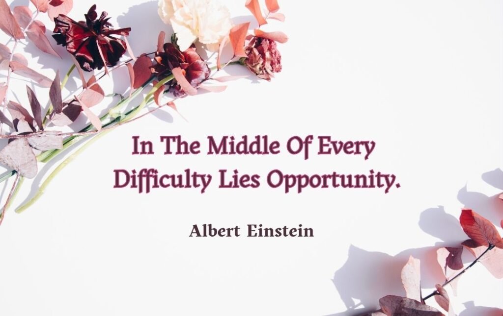 The image features a minimalistic design with a quote in the center that reads: "In the middle of every difficulty lies opportunity." - Albert Einstein. The background is white, decorated with dried and fresh flowers arranged diagonally, creating a soft and elegant aesthetic.